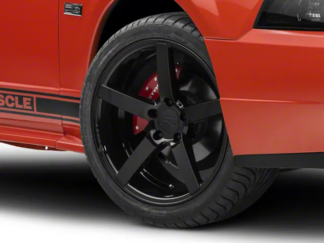 Black five-spoke aftermarket wheel and performance tire installed on a 1999–2004 Ford Mustang GT.